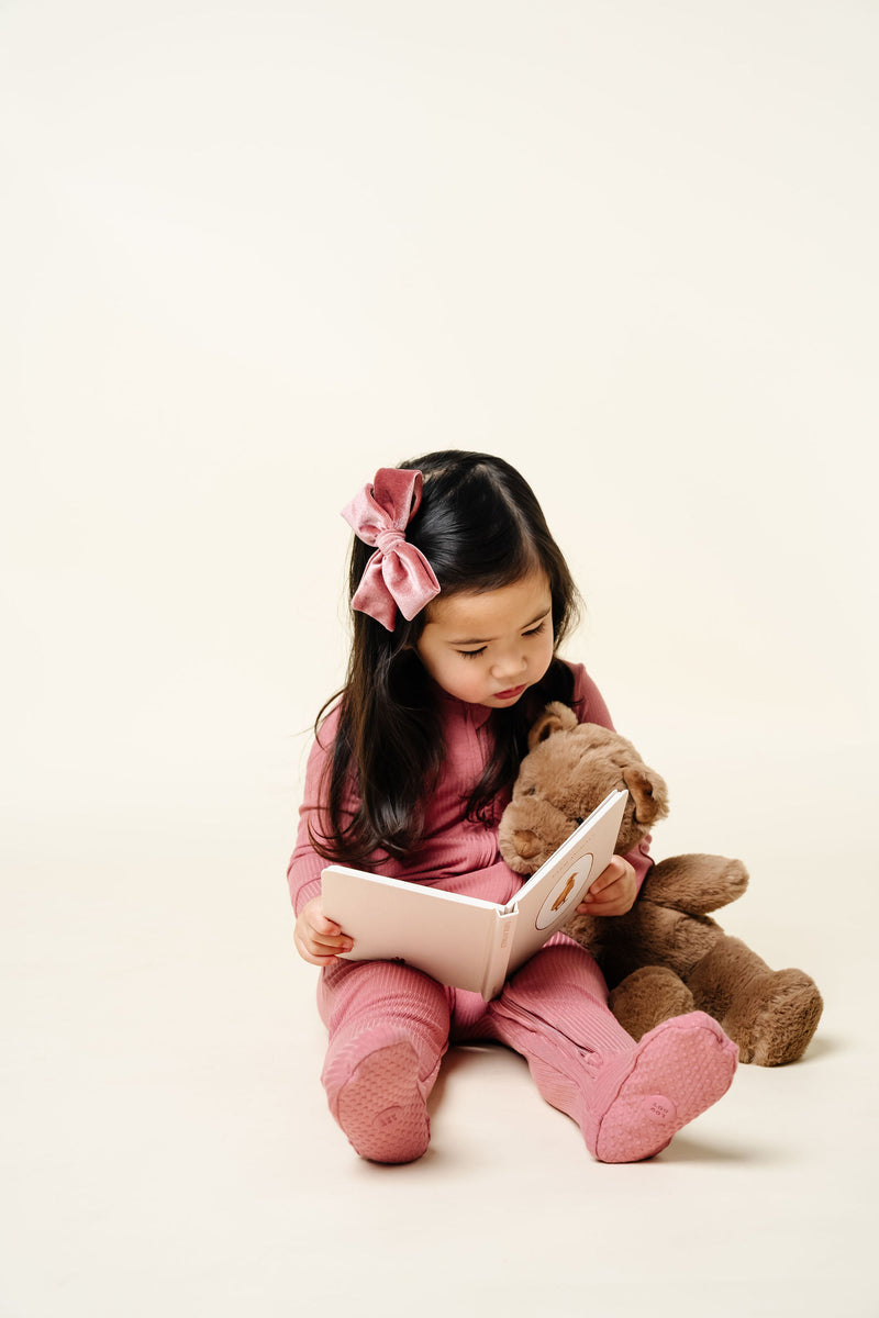 Marjorie Zipper Footie Toddler Girl in 2T size sitting reading a book