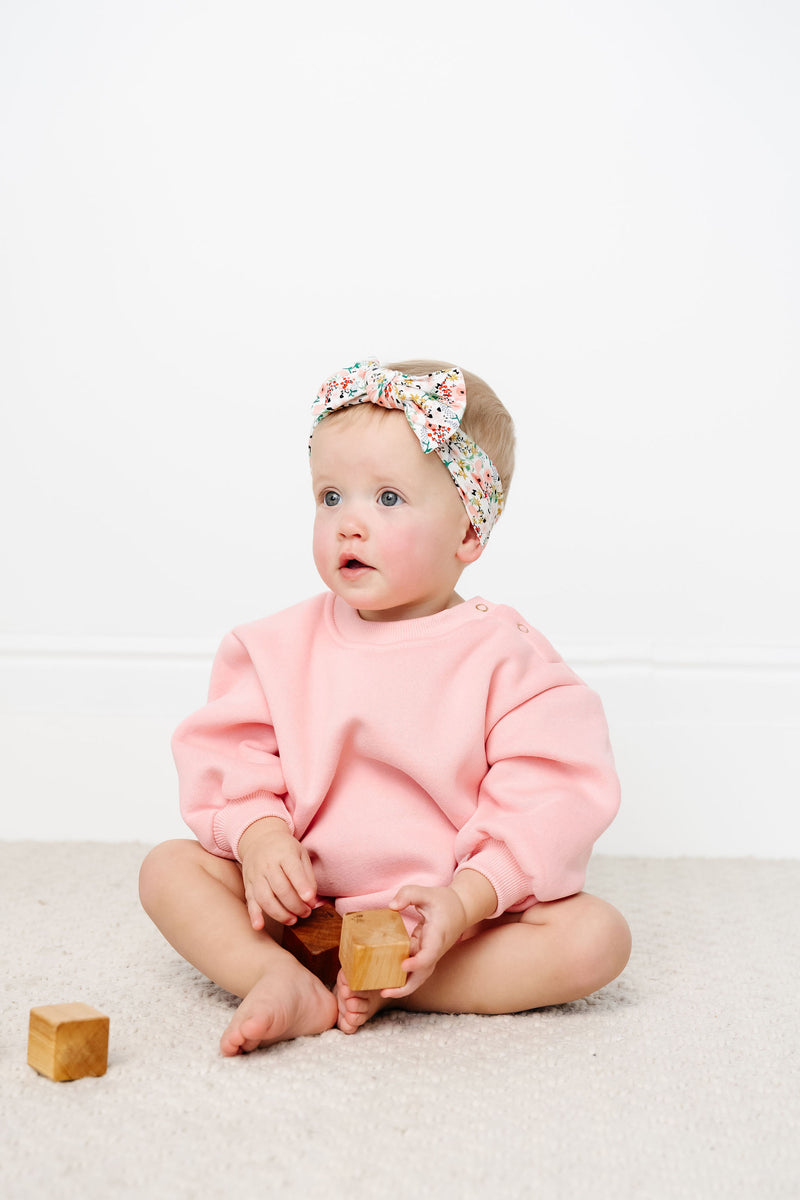 bubblegum sweatshirt romper toddler girl sitting down with matching millie headband