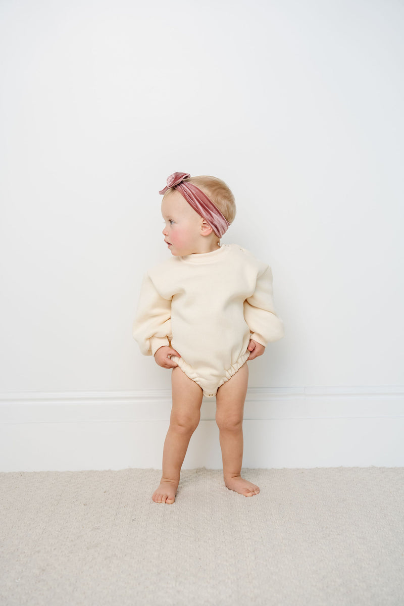 cream sweatshirt romper toddler girl standing