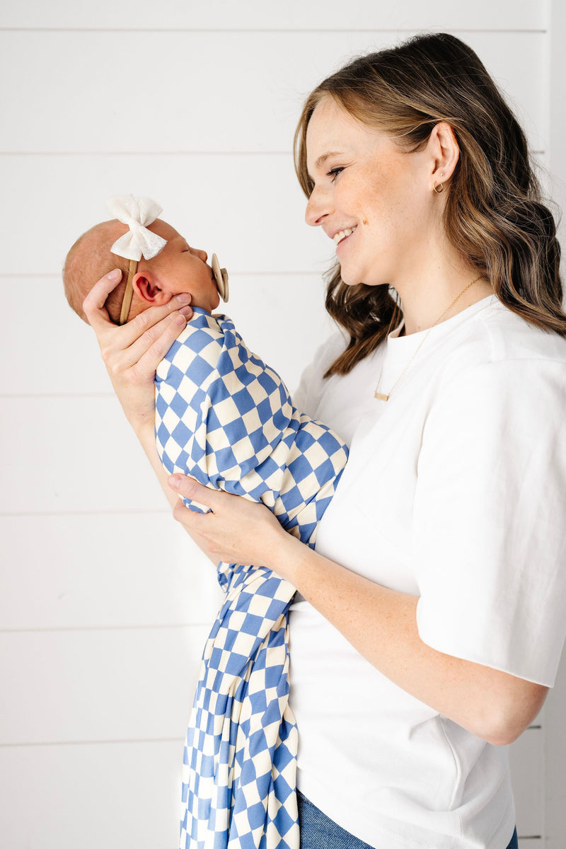 jett swaddle blanket newborn girl swaddled being held by mom