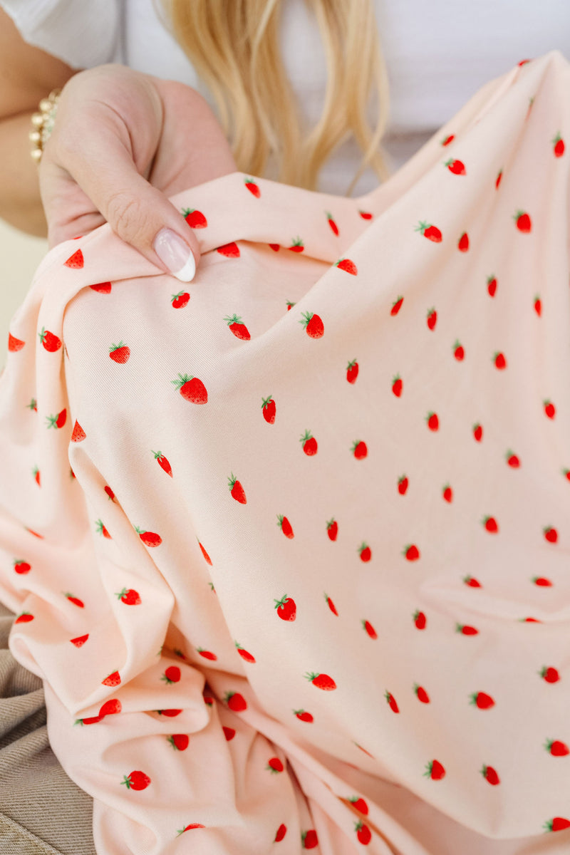 strawberry swaddle zoom up on junie strawberry print