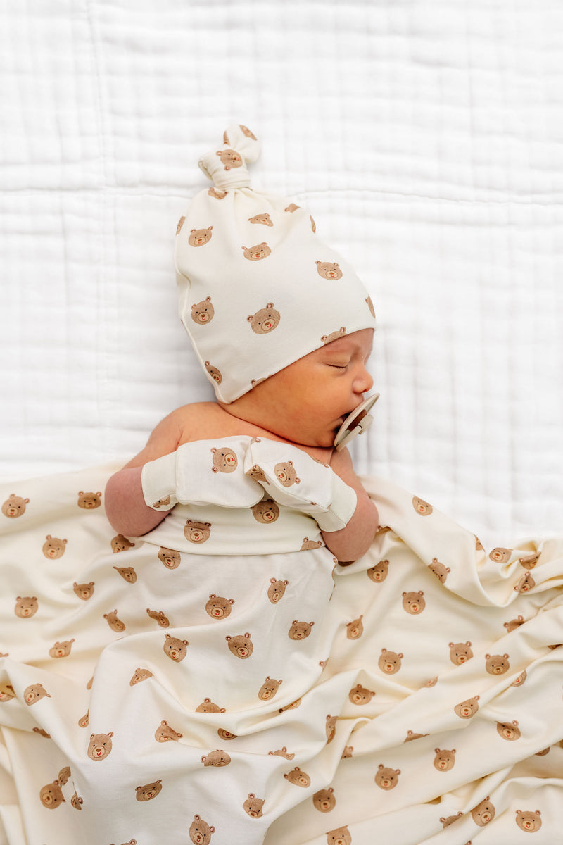 teddy hat bundle top knot hat and mittens newborn boy laying on bed