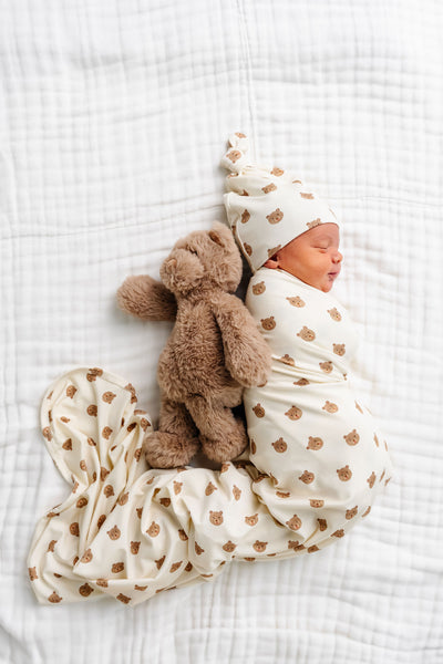 teddy swaddle blanket newborn boy with teddy bear laying on bed