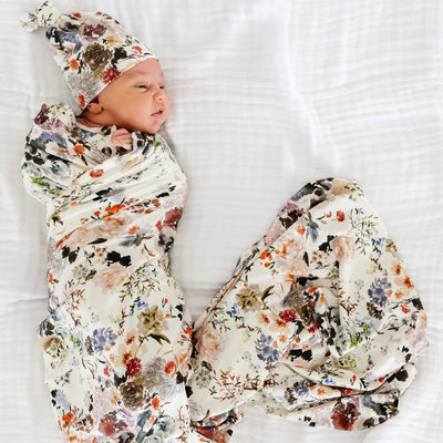 baby wrapped in the nellie swaddle blanket and wearing the nellie hat