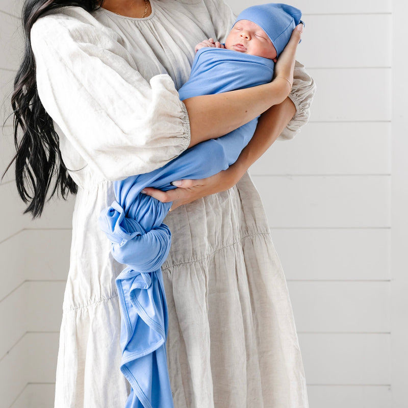 perry swaddle blanket newborn boy being held by mom